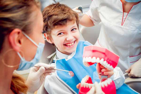 Little,Boy,With,Dentures,In,The,Dental,Office.